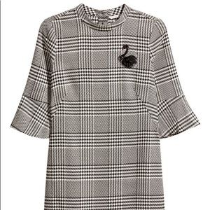 H&M short black and white houndstooth dress with black sequin swan pin detail